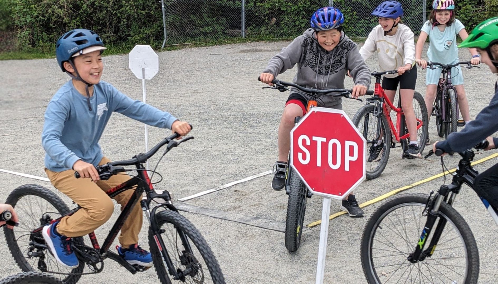 Students ride their bikes on a school playground.