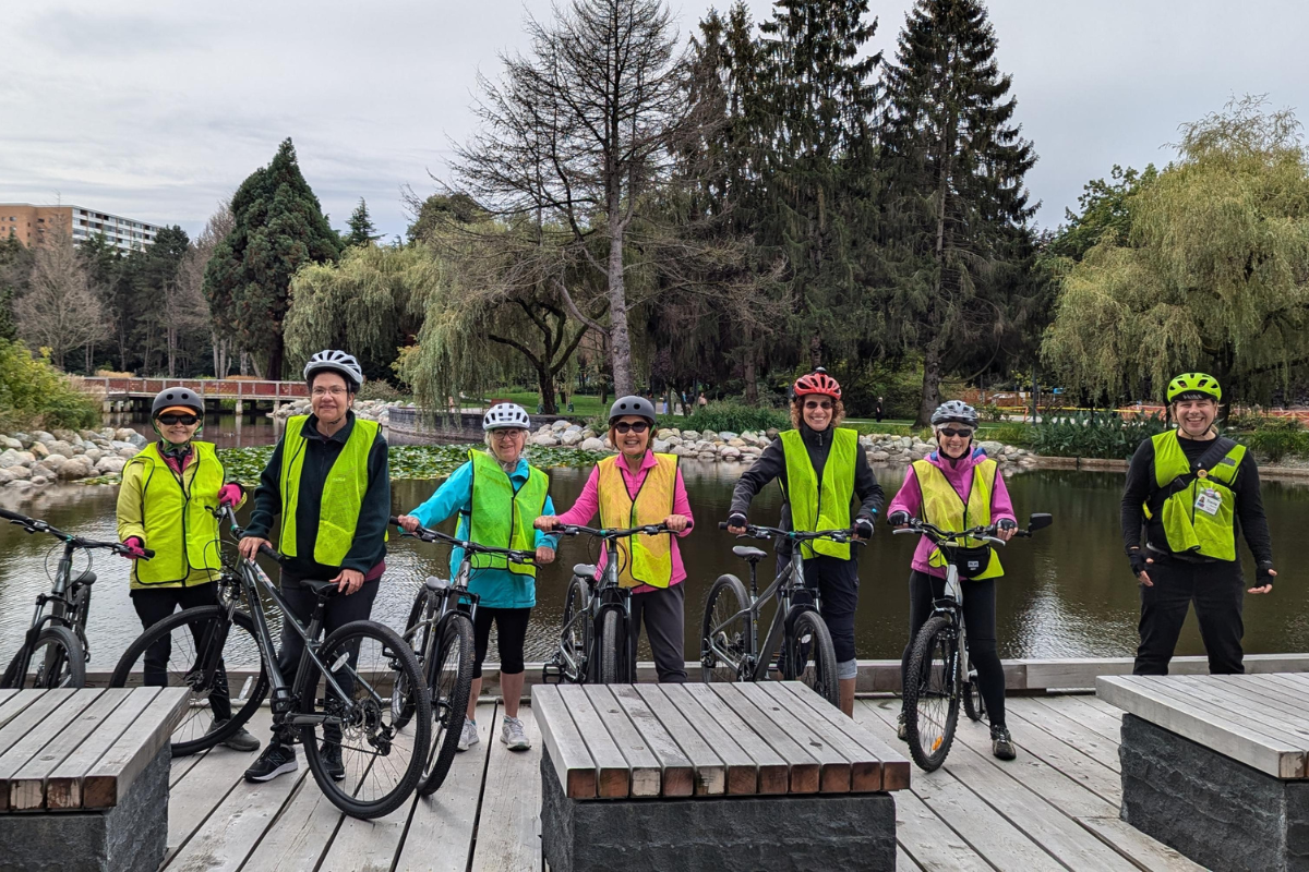 Several participants stand with their bikes on a dock.