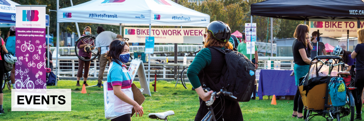 'Events'. Two women talked to each other outside a Bike to Work Week station. Other people are talking in the background.