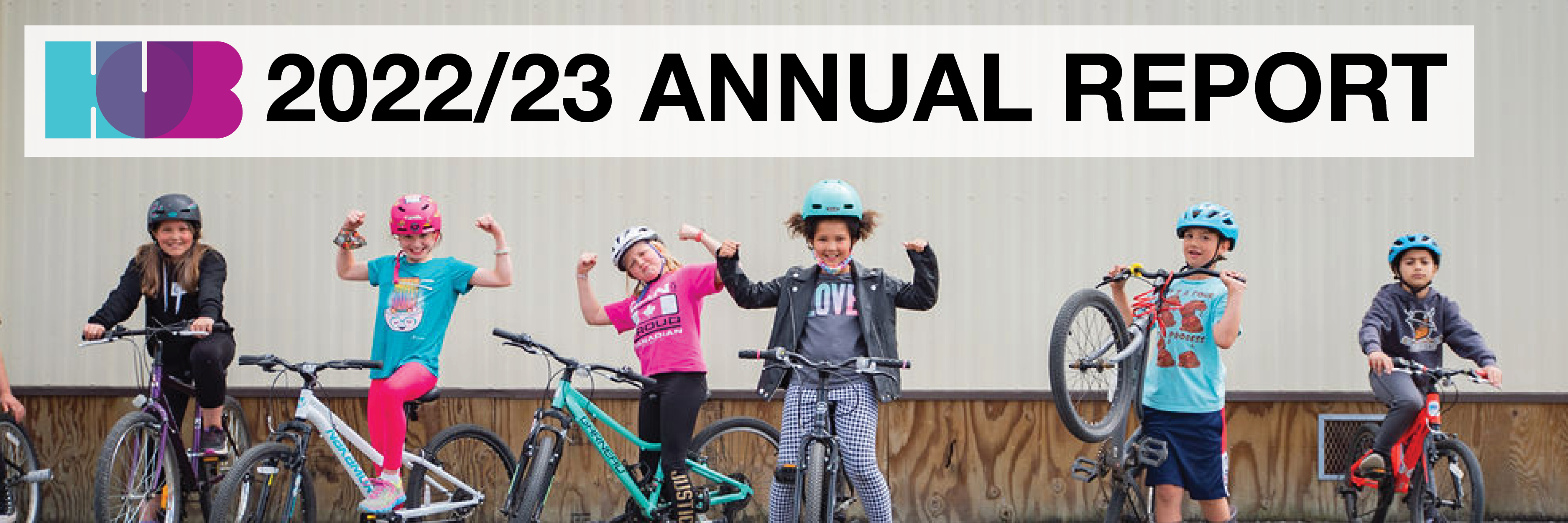2022/23 Annual Report. A group of Grade 4/5 students stand in a row with their bikes on school grounds.