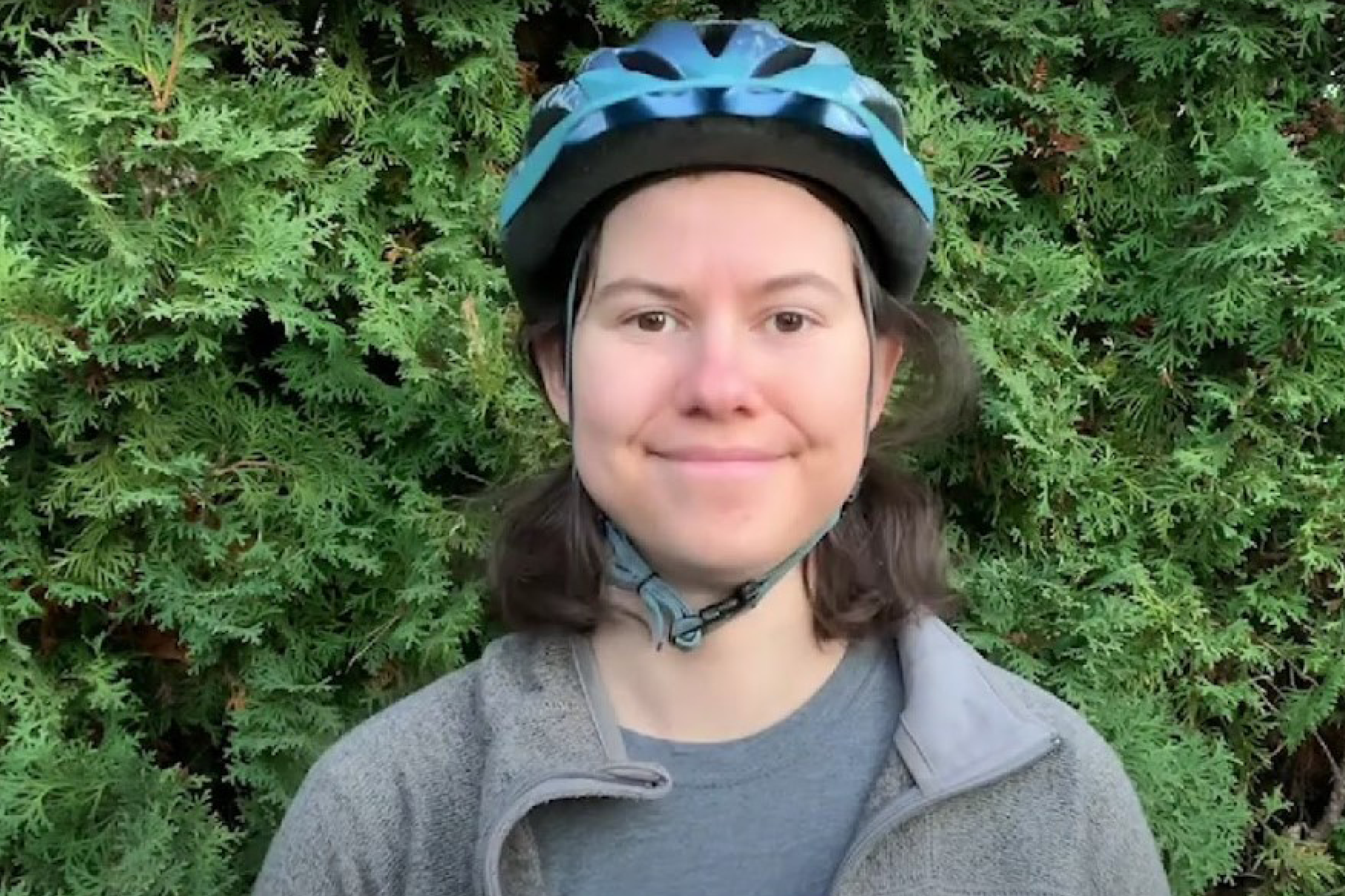 A woman wearing a bike helmet.