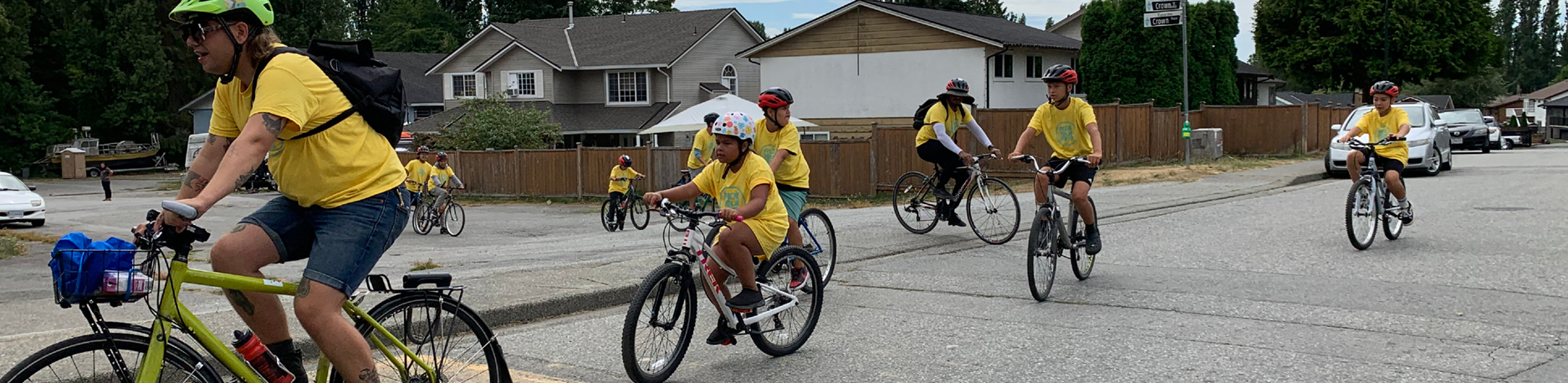 A photo of students and an instructor riding bikes on the road.