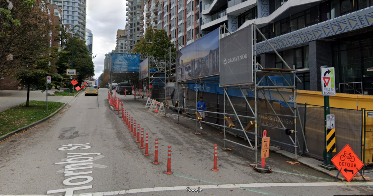 Detour on Hornby Street in the City of Vancouver. Temporary protected lane uses curb stops and delineators to maintain protection from motor vehicles