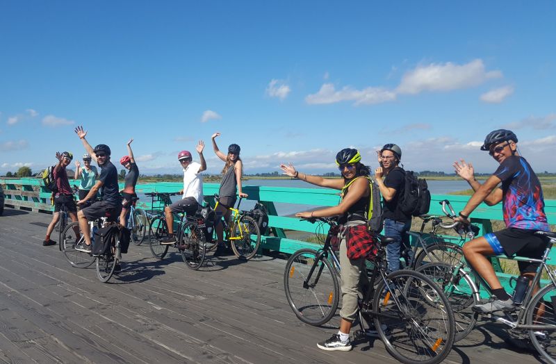 A group of HUB Cycling staff members wave at the camera during a group ride in Delta.