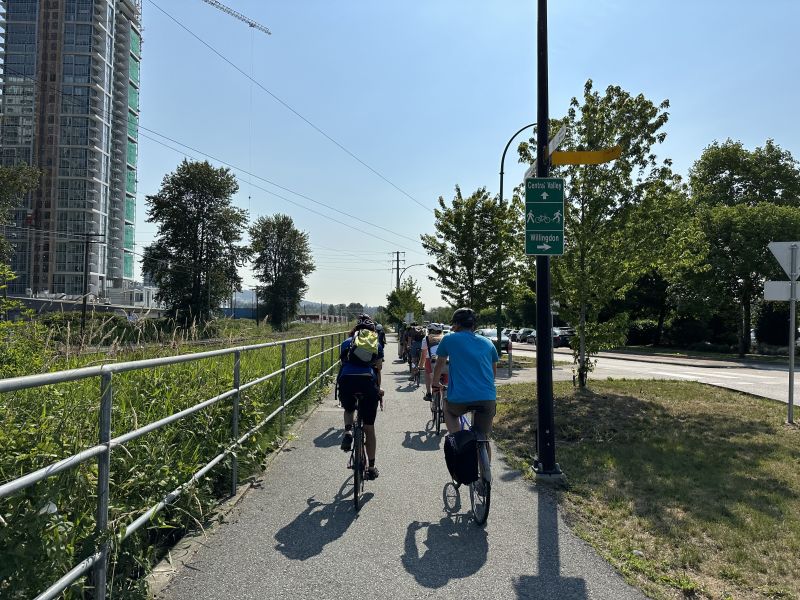 Several people cycle along the Central Valley Greenway.