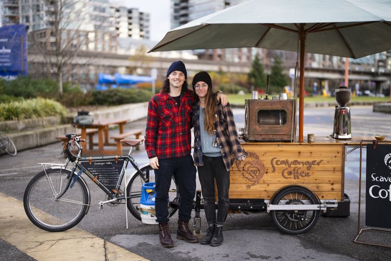 Diana Lupieri and Rory Johnston stand in front of their mobile coffee cart.