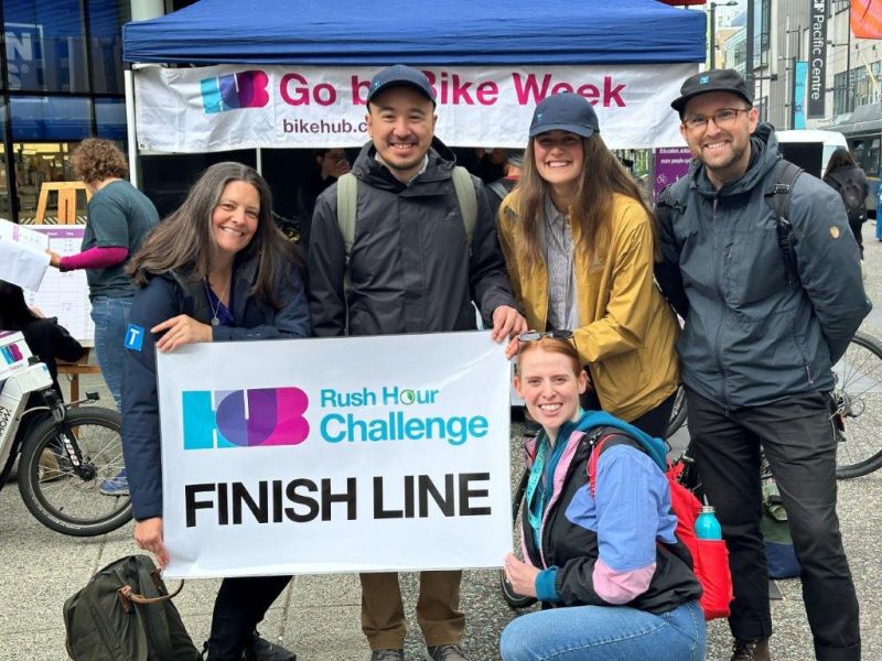 TransLink staff pose with the finish line poster.