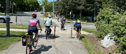 A group of people cycle along a multi-use path.